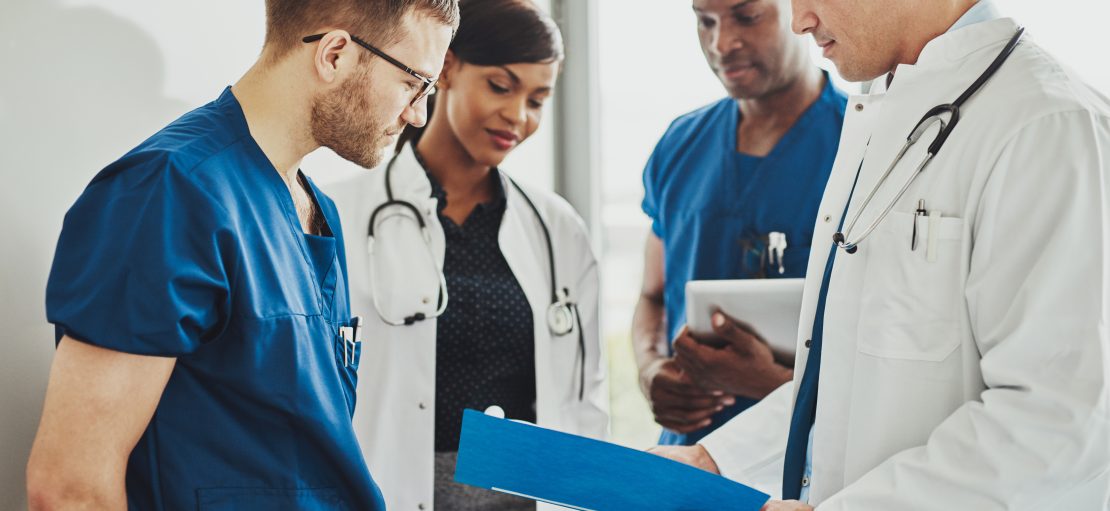 Group of doctors reading a document